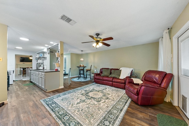 6506 Kentwick Dr, Houston, TX 77084 - living area with baseboards, visible vents, a ceiling fan, and wood finished floors