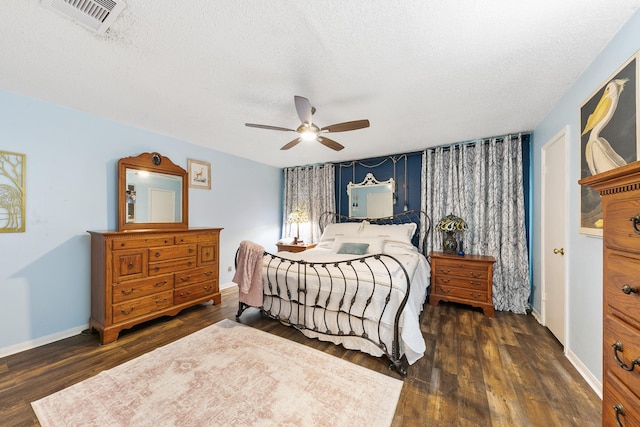 6506 Kentwick Dr, Houston, TX 77084 - bedroom with a textured ceiling, visible vents, baseboards, a ceiling fan, and dark wood finished floors