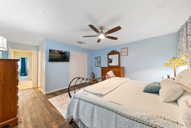 6506 Kentwick Dr, Houston, TX 77084 - bedroom featuring a closet, a ceiling fan, wood finished floors, a textured ceiling, and visible vents