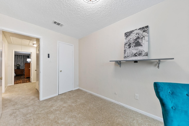 6506 Kentwick Dr, Houston, TX 77084 - unfurnished bedroom with a textured ceiling, visible vents, baseboards, attic access, and carpet floors