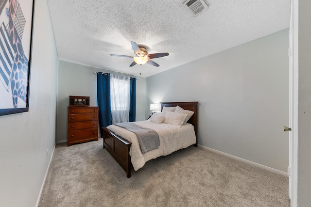 6506 Kentwick Dr, Houston, TX 77084 - bedroom with light carpet, baseboards, a ceiling fan, and a textured ceiling