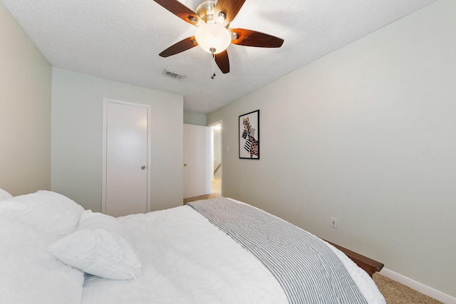 6506 Kentwick Dr, Houston, TX 77084 - carpeted bedroom with baseboards, a textured ceiling, visible vents, and a ceiling fan