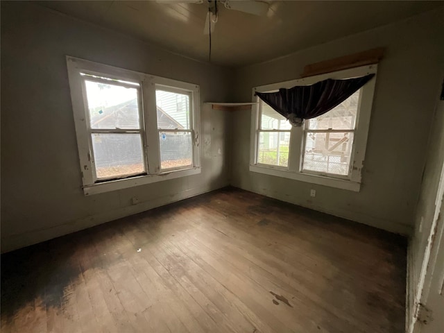 unfurnished room with a ceiling fan and hardwood / wood-style flooring