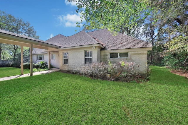 5 Briarwood Dr, Conroe, TX 77301 - back of property featuring a yard, brick siding, and a shingled roof