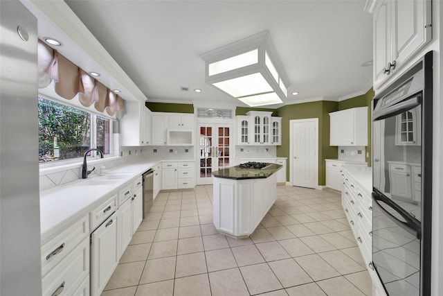5 Briarwood Dr, Conroe, TX 77301 - kitchen with tasteful backsplash, stainless steel dishwasher, a sink, and light tile patterned floors