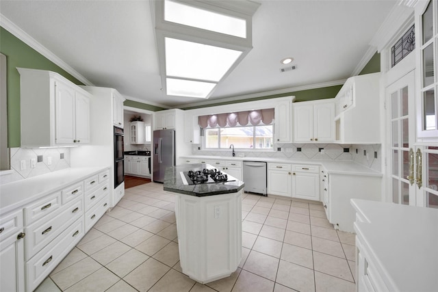 5 Briarwood Dr, Conroe, TX 77301 - kitchen featuring light tile patterned floors, a center island, crown molding, decorative backsplash, and stainless steel appliances