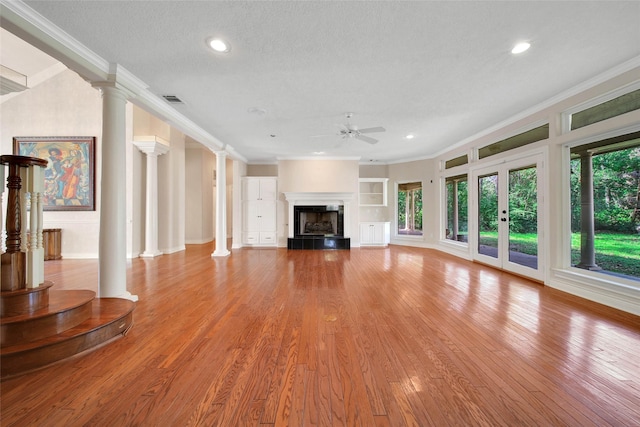 5 Briarwood Dr, Conroe, TX 77301 - unfurnished living room featuring wood finished floors, visible vents, crown molding, and ceiling fan