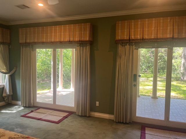 5 Briarwood Dr, Conroe, TX 77301 - doorway featuring crown molding, visible vents, baseboards, and carpet