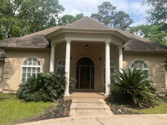 5 Briarwood Dr, Conroe, TX 77301 - doorway to property with stucco siding and roof with shingles