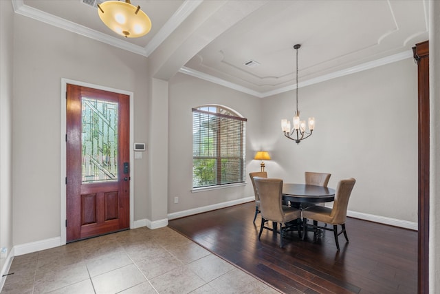 dining area with a chandelier, visible vents, baseboards, and ornamental molding