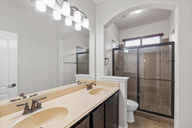 bathroom featuring tile patterned floors, a sink, and a stall shower