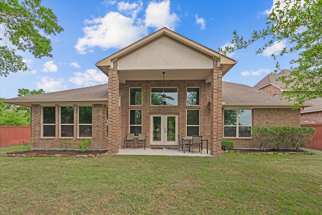 rear view of house featuring french doors, a patio area, fence, and a yard