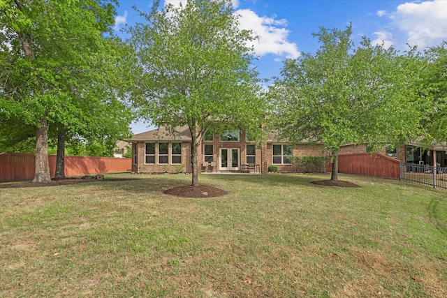 view of yard featuring french doors and fence