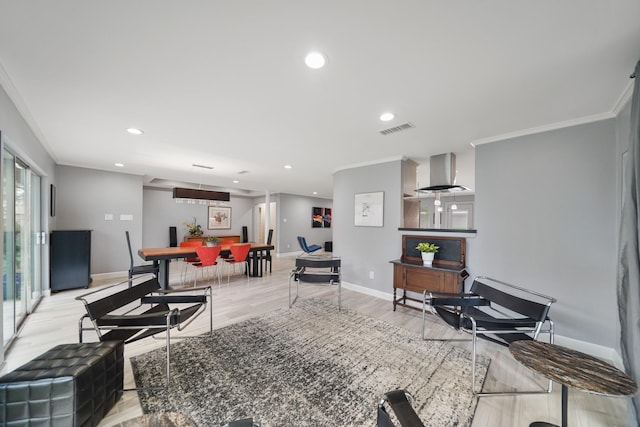 living room with visible vents, baseboards, ornamental molding, light wood-style floors, and recessed lighting