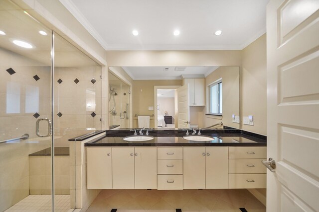 bathroom featuring a shower stall, a sink, and ornamental molding