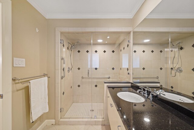 full bathroom featuring baseboards, crown molding, vanity, tile patterned flooring, and a stall shower