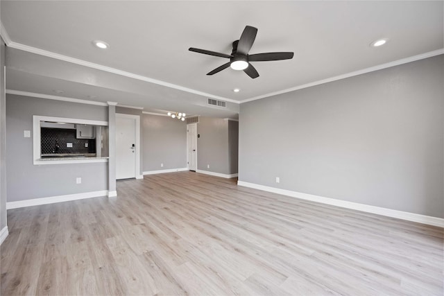 unfurnished living room featuring visible vents, light wood finished floors, baseboards, ornamental molding, and ceiling fan with notable chandelier