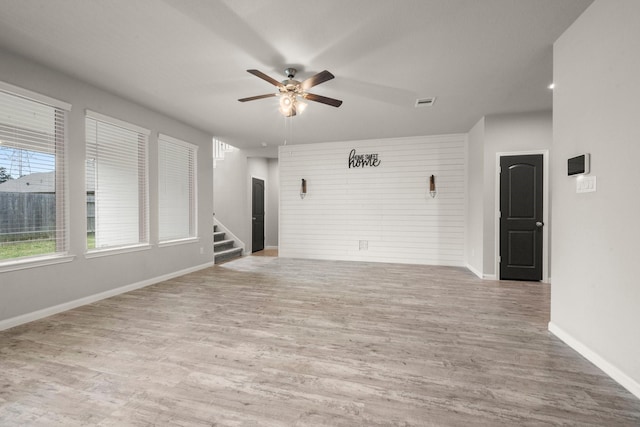 12627 Beddington Ct, Tomball, TX 77375 - unfurnished room with ceiling fan, stairs, wood finished floors, and baseboards