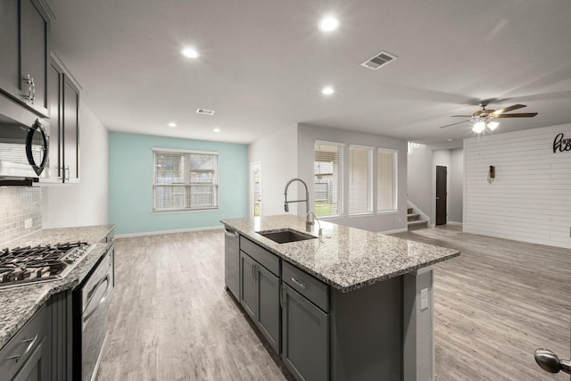 12627 Beddington Ct, Tomball, TX 77375 - kitchen featuring a sink, open floor plan, appliances with stainless steel finishes, baseboards, and recessed lighting