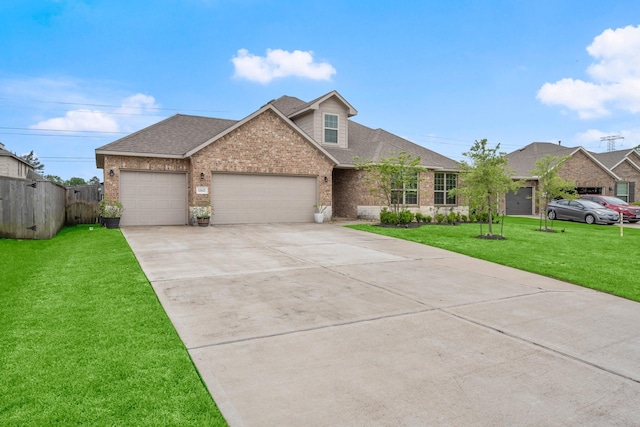 view of front of home with a shingled roof, concrete driveway, brick siding, a front yard, and a garage