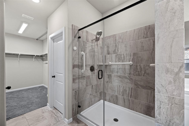 2522 Blazing Star Dr, Brookshire, TX 77423 - full bathroom featuring a shower stall, a walk in closet, marble finish flooring, and baseboards