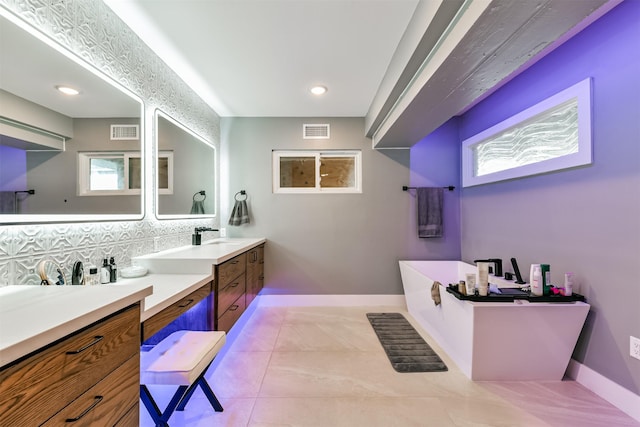 2415 Church St, Galveston, TX 77550 - bathroom featuring backsplash, a soaking tub, baseboards, and visible vents