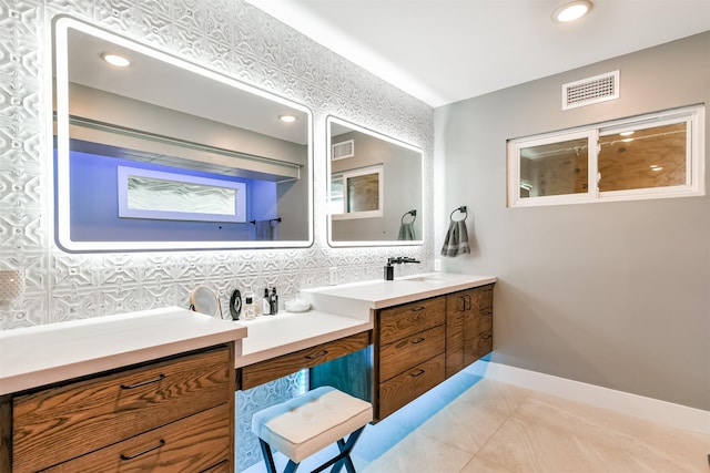 2415 Church St, Galveston, TX 77550 - full bathroom with tile patterned flooring, vanity, tasteful backsplash, baseboards, and visible vents