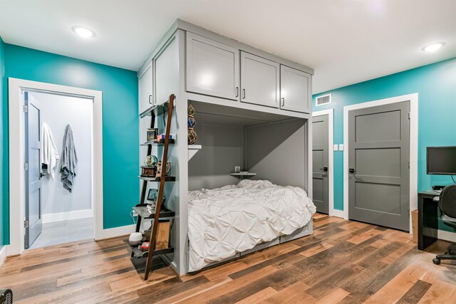 2415 Church St, Galveston, TX 77550 - bedroom featuring baseboards, visible vents, light wood-style flooring, and recessed lighting