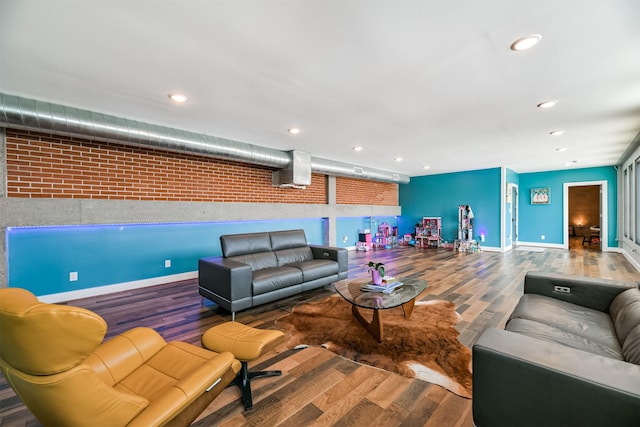 2415 Church St, Galveston, TX 77550 - living room with baseboards, wood finished floors, recessed lighting, and brick wall