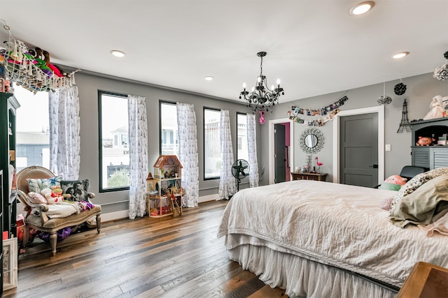 2415 Church St, Galveston, TX 77550 - bedroom with hardwood / wood-style floors, baseboards, an inviting chandelier, and recessed lighting