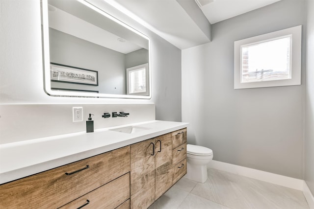 2415 Church St, Galveston, TX 77550 - bathroom with toilet, vanity, tile patterned floors, and baseboards