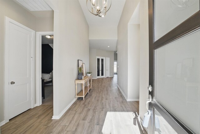 7323 Perching Hawk Trl, Katy, TX 77493 - foyer entrance featuring a notable chandelier, light wood-style flooring, and baseboards