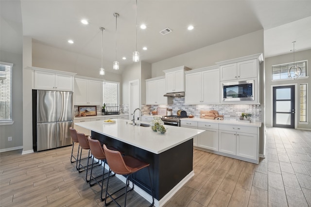 7323 Perching Hawk Trl, Katy, TX 77493 - kitchen with tasteful backsplash, visible vents, under cabinet range hood, and stainless steel appliances