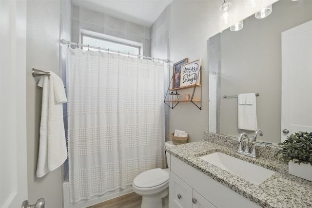 7323 Perching Hawk Trl, Katy, TX 77493 - full bath with toilet, wood finished floors, vanity, and shower / tub combo with curtain