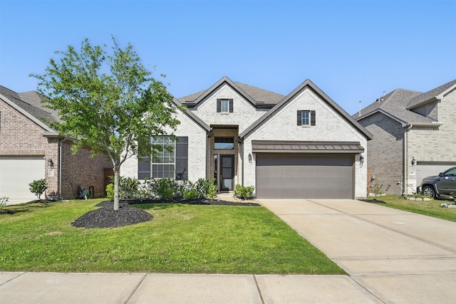 7323 Perching Hawk Trl, Katy, TX 77493 - french provincial home with driveway, a front yard, a garage, and brick siding