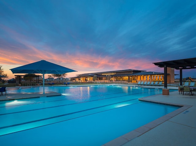 7323 Perching Hawk Trl, Katy, TX 77493 - pool at dusk with a patio area and a community pool
