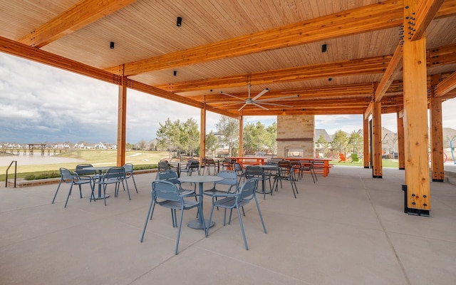 7323 Perching Hawk Trl, Katy, TX 77493 - view of patio with outdoor dining space and a multi sided fireplace