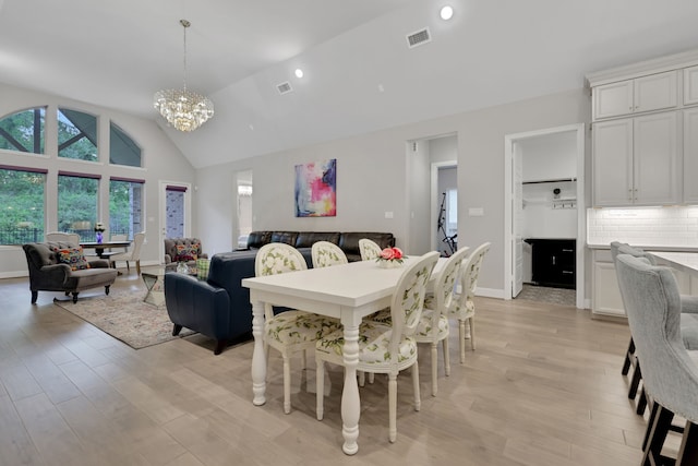 5119 Long Branch Bnd, Fulshear, TX 77441 - dining space featuring a chandelier, light wood finished floors, high vaulted ceiling, baseboards, and recessed lighting