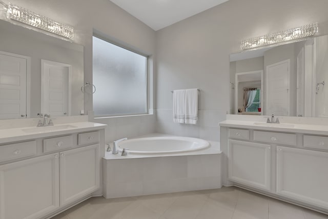 5119 Long Branch Bnd, Fulshear, TX 77441 - bathroom with tile patterned flooring, healthy amount of natural light, two vanities, and a garden tub