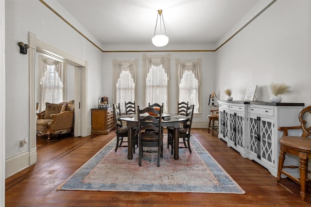 712 Lamar Ave, Crockett, TX 75835 - dining room with baseboards and dark wood-style flooring