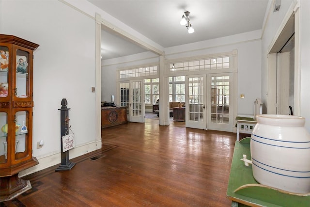712 Lamar Ave, Crockett, TX 75835 - foyer with french doors, visible vents, beamed ceiling, and wood finished floors