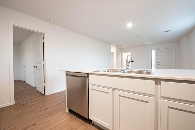 913 Oak Mist Ln, Magnolia, TX 77354 - kitchen featuring white cabinets, a sink, baseboards, light wood-type flooring, and stainless steel dishwasher