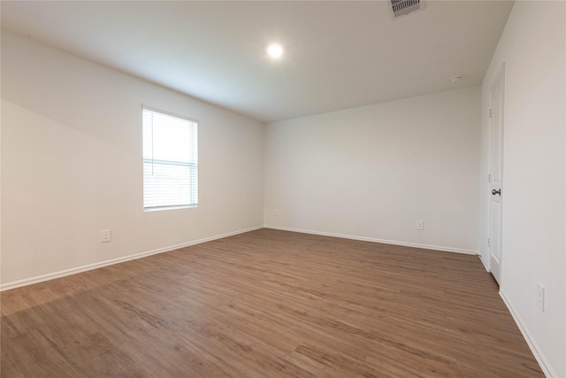913 Oak Mist Ln, Magnolia, TX 77354 - empty room featuring baseboards, visible vents, and wood finished floors