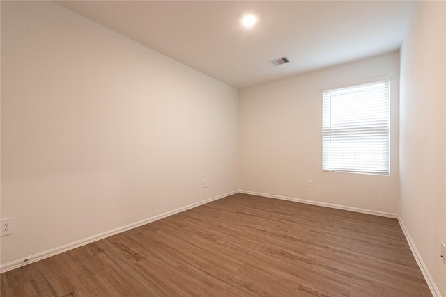 913 Oak Mist Ln, Magnolia, TX 77354 - empty room featuring baseboards, visible vents, and wood finished floors