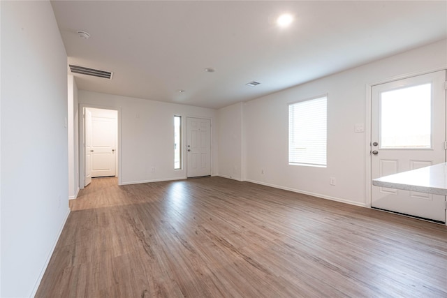 913 Oak Mist Ln, Magnolia, TX 77354 - interior space featuring baseboards, visible vents, plenty of natural light, and light wood-style flooring