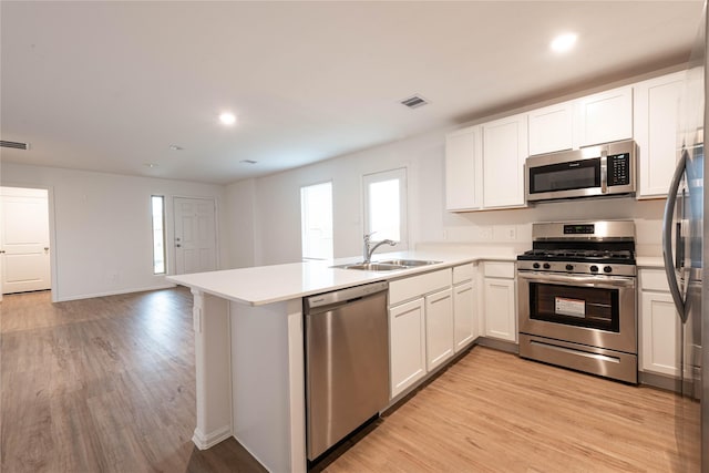 913 Oak Mist Ln, Magnolia, TX 77354 - kitchen with a sink, appliances with stainless steel finishes, plenty of natural light, and a peninsula