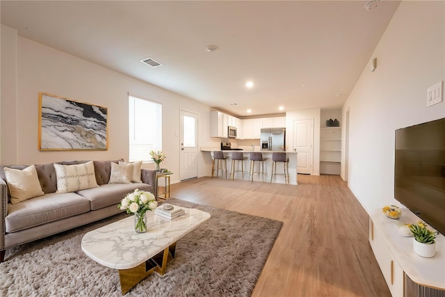 913 Oak Mist Ln, Magnolia, TX 77354 - living room with recessed lighting, light wood finished floors, and visible vents