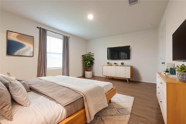 913 Oak Mist Ln, Magnolia, TX 77354 - bedroom with visible vents, baseboards, and light wood-type flooring