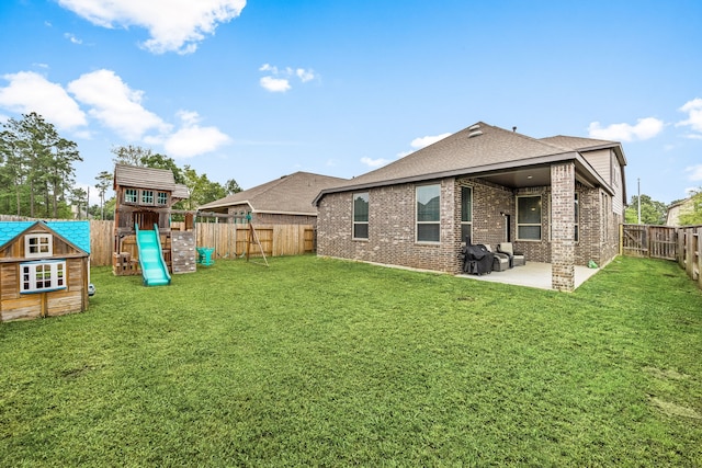 16875 Olympic National Dr, Humble, TX 77346 - back of house with a patio, brick siding, a playground, and roof with shingles