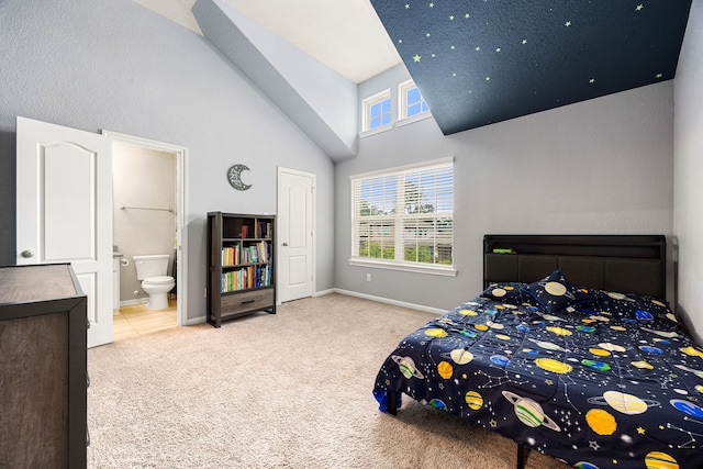 16875 Olympic National Dr, Humble, TX 77346 - bedroom with high vaulted ceiling, carpet floors, ensuite bath, and baseboards